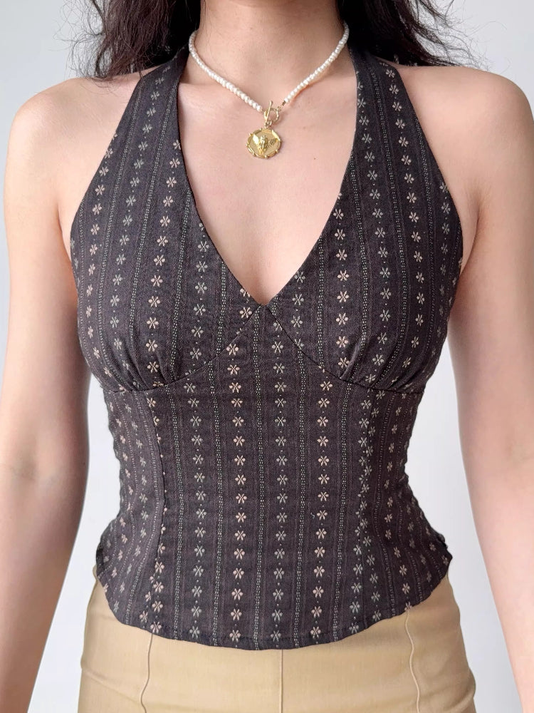 Close-up of a dark patterned halter top with a v-neckline.