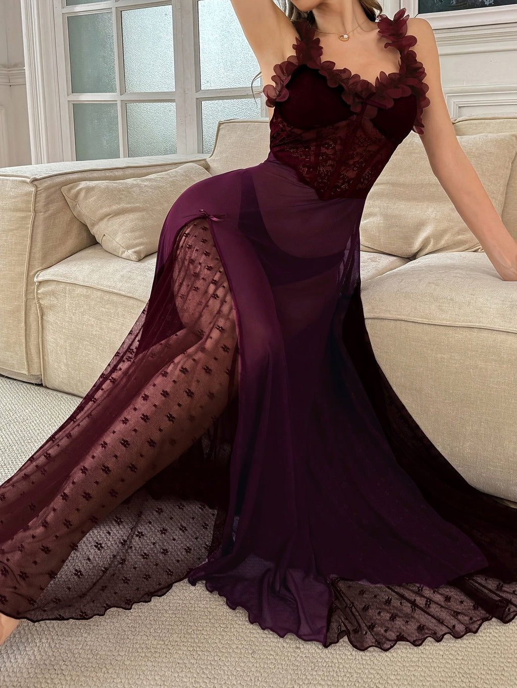 Close-up of a woman's legs through the sheer plum slip dress, revealing lace patterned hosiery.