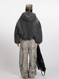 Back view of a woman in a charcoal grey textured puffer jacket.
