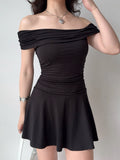 Close-up of a black off-the-shoulder dress with ruched detailing