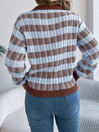 Back view of a woman in a blue and brown striped knit sweater