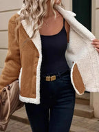Woman showing the inside of a brown jacket lined with white sherpa.