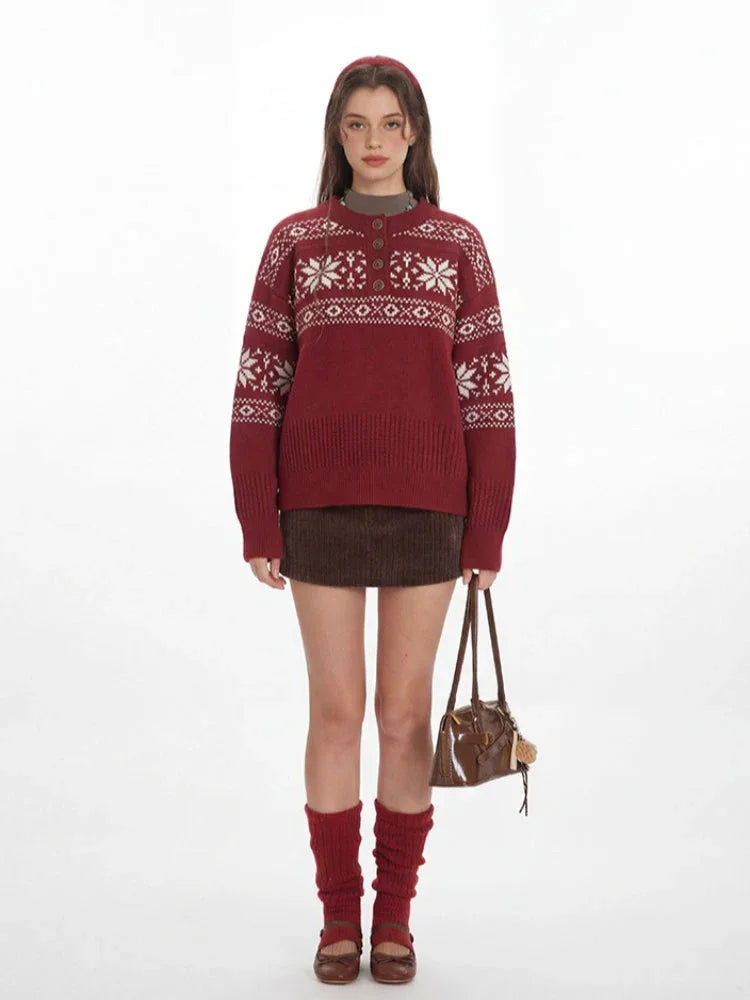 Woman wearing a red knit sweater with a white Fair Isle pattern and a button placket.