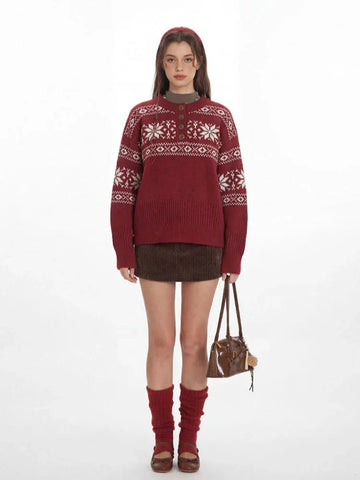 Woman wearing a red knit sweater with a white Fair Isle pattern and a button placket.