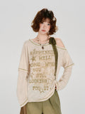 Close-up of the graphic print on the cream-colored t-shirt.