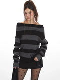 Woman wearing a grey and black striped knit sweater styled off-the-shoulder, black shorts, black patterned tights, and black boots.