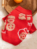 Overhead view of a red knit dog sweater with tan Chinese characters