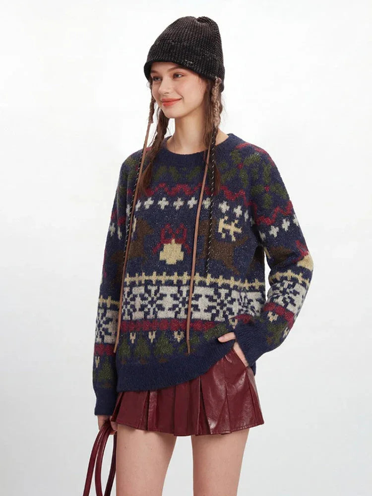 Close-up of a woman wearing a navy blue knit sweater with a detailed Fair Isle pattern.