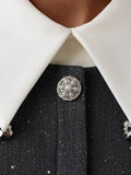 Detail of the sequin trim and lace hem on a grey mini dress