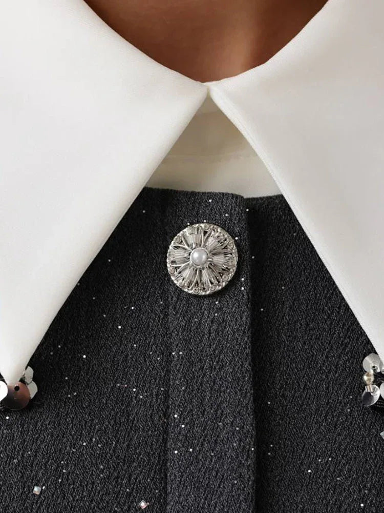 Detail of the sequin trim and lace hem on a grey mini dress
