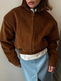Front view of a brown corduroy bomber jacket with elasticated hem.