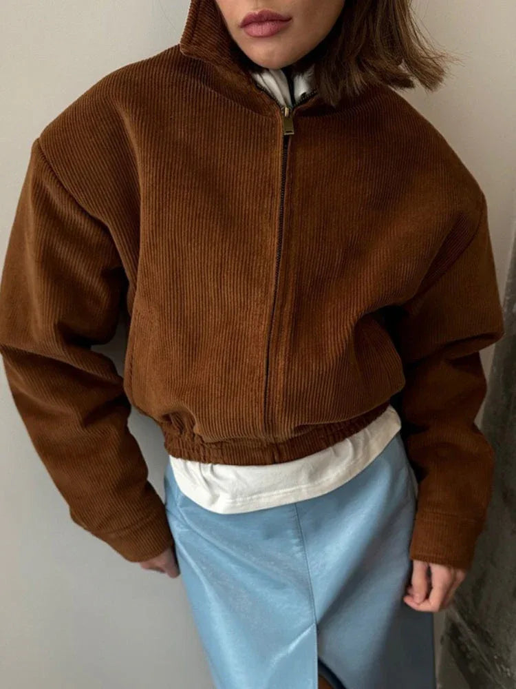 Front view of a brown corduroy bomber jacket with elasticated hem.