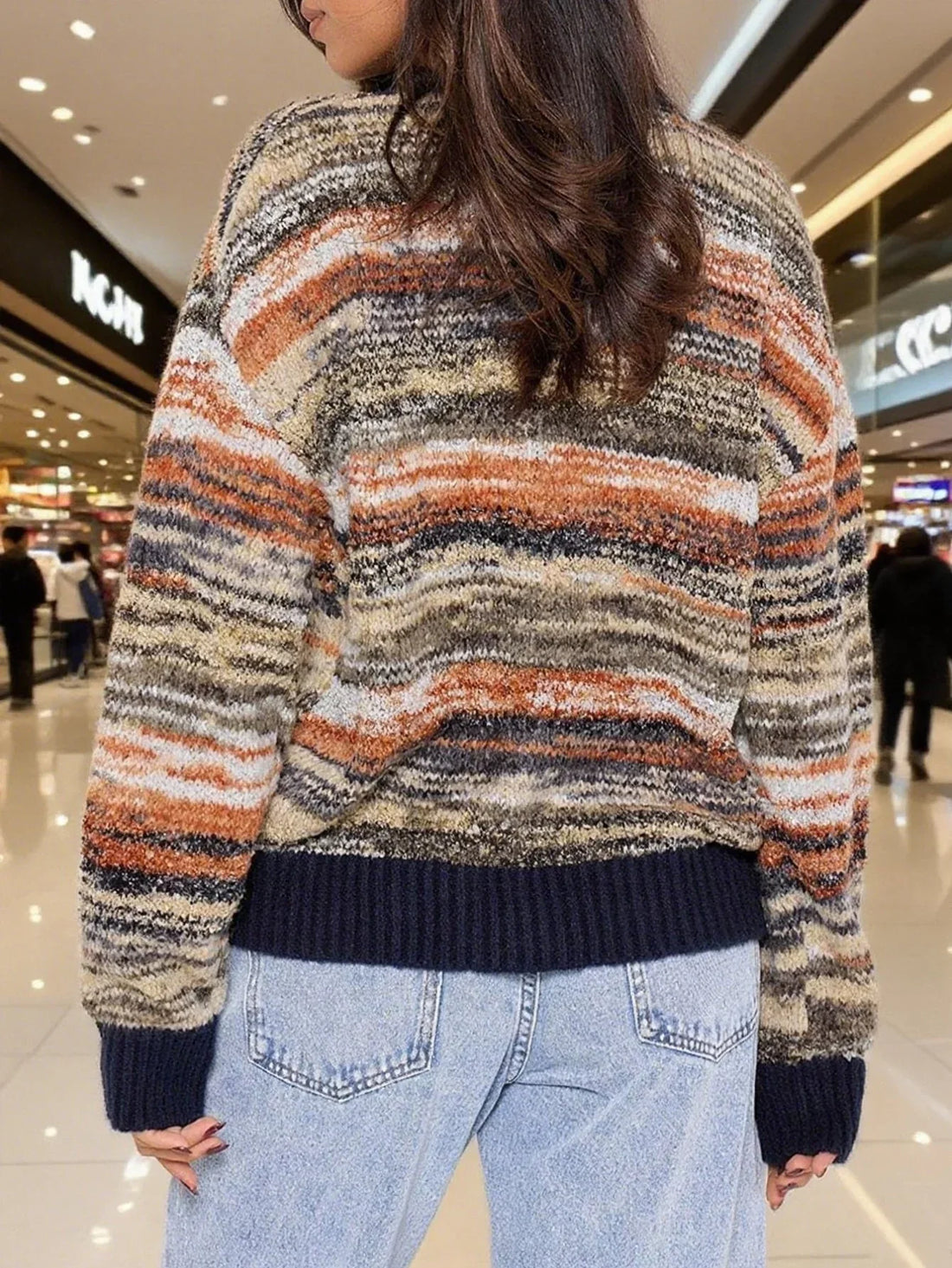 Woman wearing a multicolored striped knit cardigan with a V-neck and button-up front