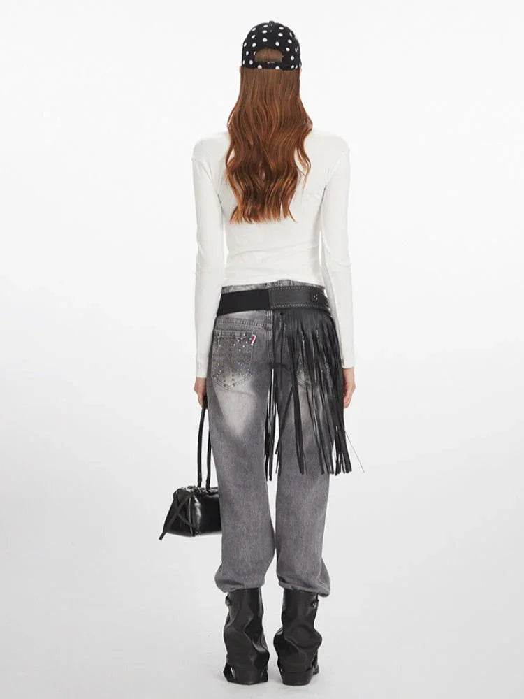 Back view of a woman in a white long-sleeve graphic t-shirt.