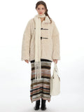 Cream fleece toggle coat with a white scarf and striped skirt