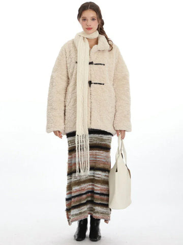 Cream fleece toggle coat with a white scarf and striped skirt