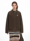 Close-up of the embroidered detail on the brown bomber jacket