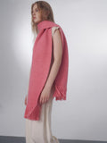 Close-up of a woman wearing a pink textured scarf