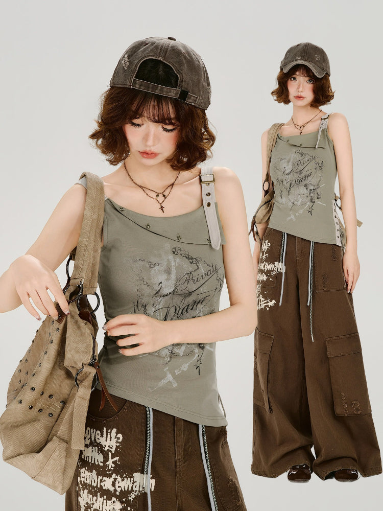 Woman posing with a tan canvas shoulder bag and a green graphic print tank top