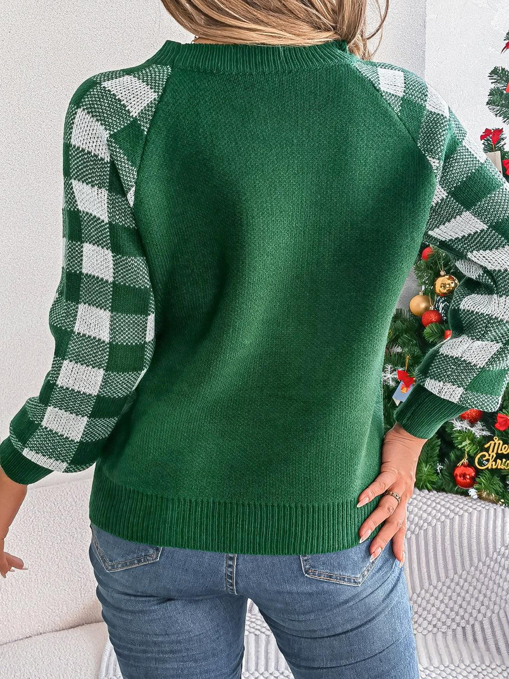 Woman wearing a white and red festive reindeer knit sweater with buffalo plaid raglan sleeves. - View 13 | WEUXS