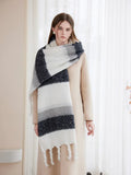 Front view of a woman showcasing a wide, cozy scarf with a multi-color stripe design