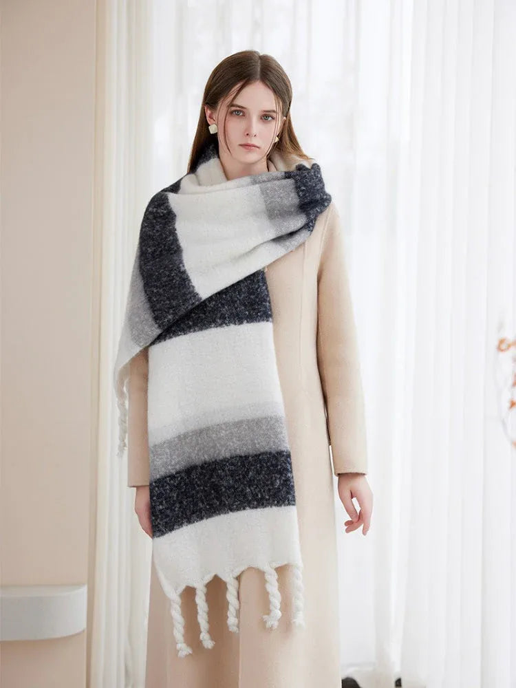 Front view of a woman showcasing a wide, cozy scarf with a multi-color stripe design