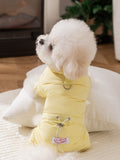 Rear view of a small dog in a yellow puffer jacket with leash attachment