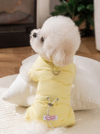 Rear view of a small dog in a yellow puffer jacket with leash attachment