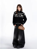 Full body shot of woman in black Fair Isle dachshund cardigan
