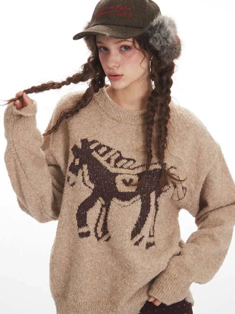 Detail shot of the horse graphic on a tan knit sweater.