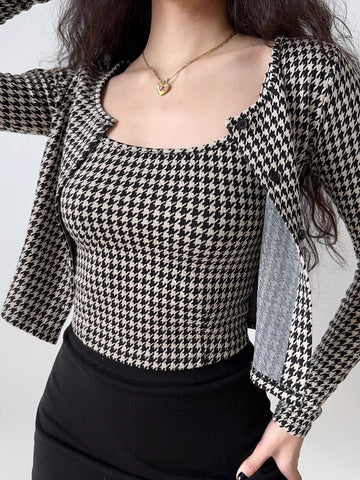 Woman wearing a black and white houndstooth print cropped cardigan and matching camisole.