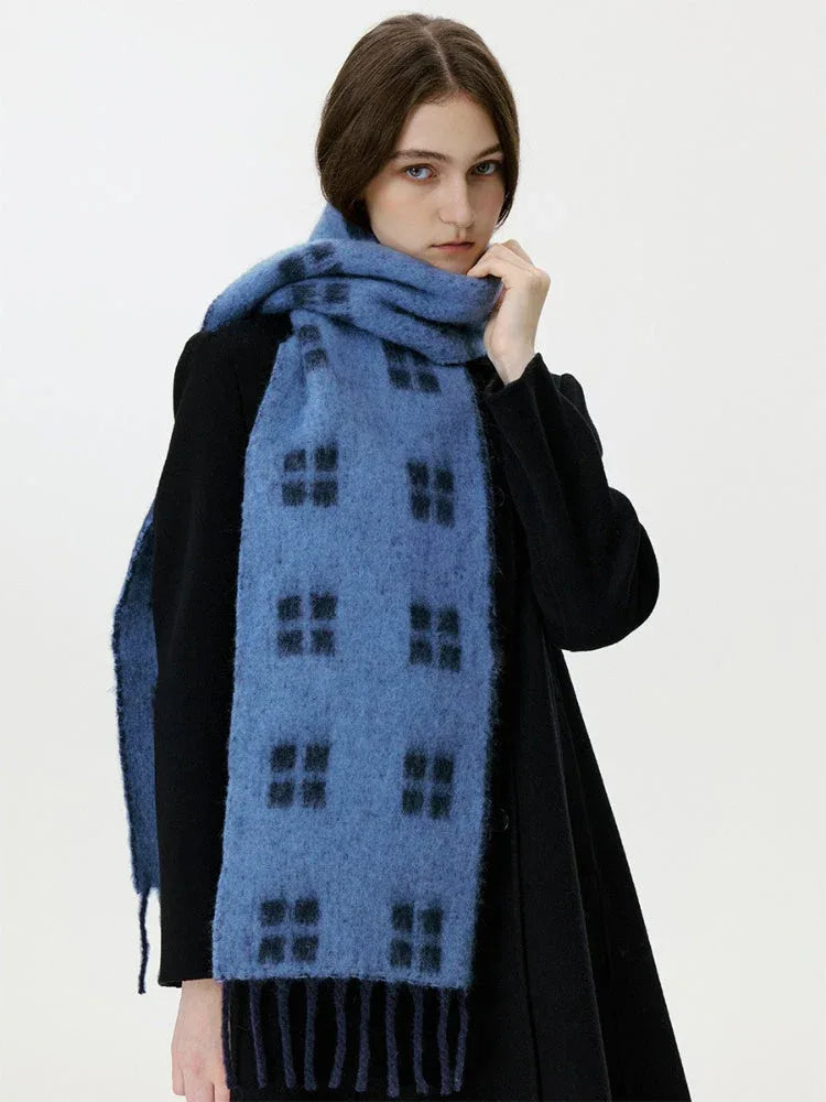 Close-up of a woman wearing a blue scarf with a black windowpane plaid pattern