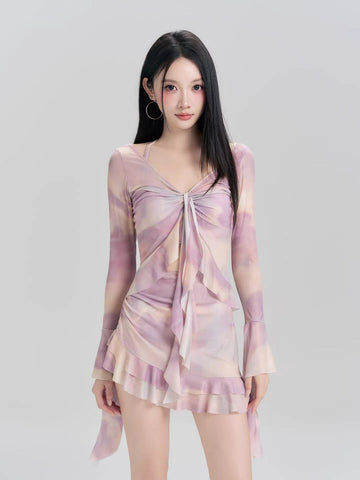 Woman wearing a lavender and peach tie-dye mesh long sleeve mini dress with ruffled hem