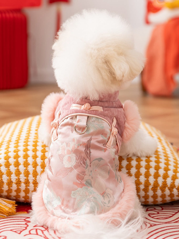 Rear view of a white dog wearing a pink dog coat with traditional Chinese style closure and floral embroidery