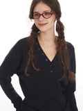 Detail of the neckline of a navy long-sleeve henley shirt.