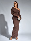 Woman wearing a brown long-sleeve one-shoulder draped maxi dress