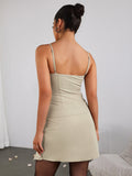 Back view of a woman in a beige sheath dress