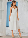 Side profile of a woman in a black crepe sheath dress with a sweetheart neckline, one hand in pocket.