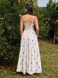 Back view of a woman in a white floral print maxi dress with a lace-up corset detail at the back.