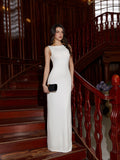 Woman in a white sleeveless evening gown with a round neckline on a staircase