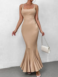 Woman wearing a beige ribbed knit maxi dress with a square neckline and fishtail hem