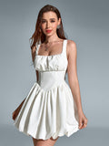 Model posing in a white square neck balloon hem dress