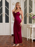 Woman wearing a wine-colored satin maxi dress with a cowl neckline and spaghetti straps.