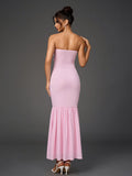 Back view of a woman in a pink strapless mermaid gown.