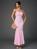 Full length shot of a woman in a pink strapless mermaid gown.