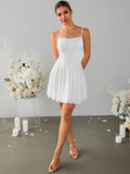Full body shot of a woman in a white lace mini dress with a square neckline