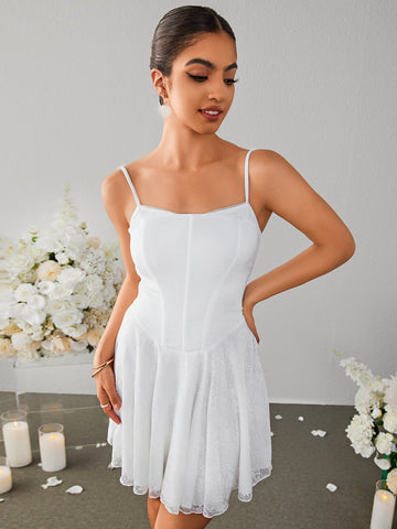 Model wearing a white lace mini dress with a square neckline and spaghetti straps