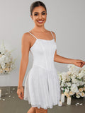 Woman posing in a white lace mini dress with a square neckline