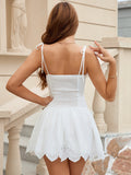 Back view of a white fit and flare mini dress with smocked back
