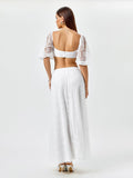 Back view of a woman in a white lace matching set